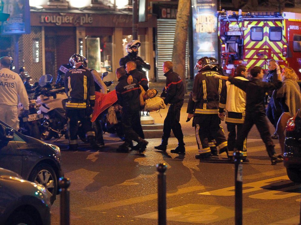 PHOTO: Medics move a wounded man near the Boulevard des Filles-du-Calvaire after an attack November 13, 2013 in Paris, France. Gunfire and explosions in multiple locations erupted in the French capital with early casualty reports indicating many dead.