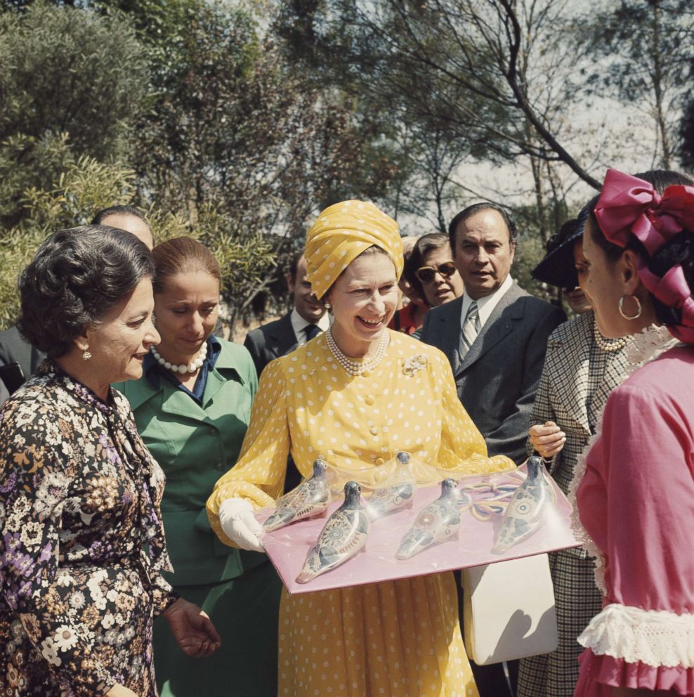 PHOTO: Queen Elizabeth II holds a tray of local crafts that she was given during her state visit to Mexico in 1975. 