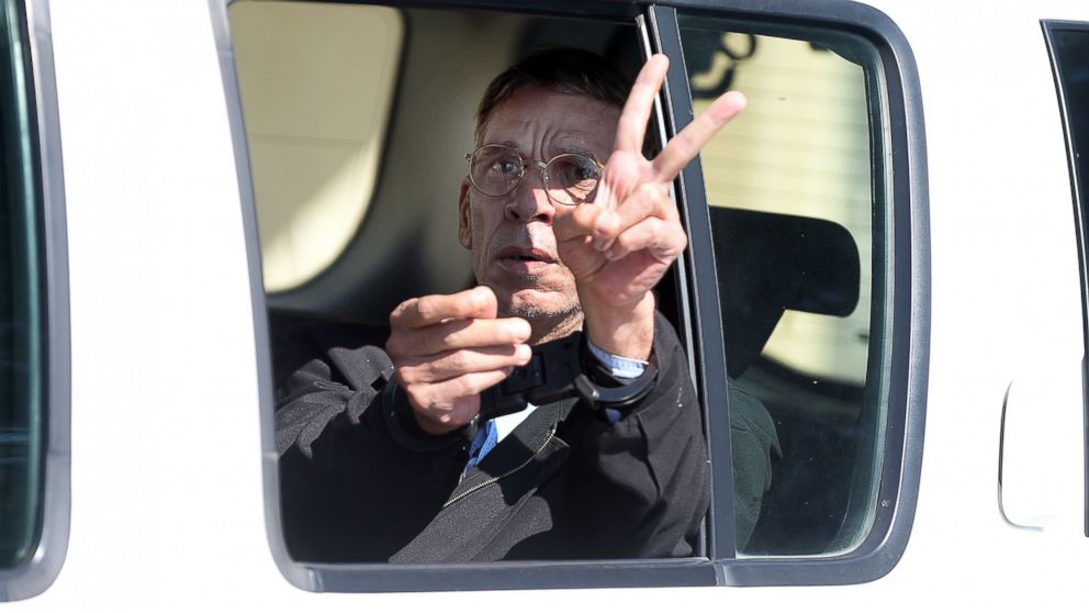 Handcuffed Seif Eldin Mustafa leaves the court in Larnaca in a police car, March 30, 2016.