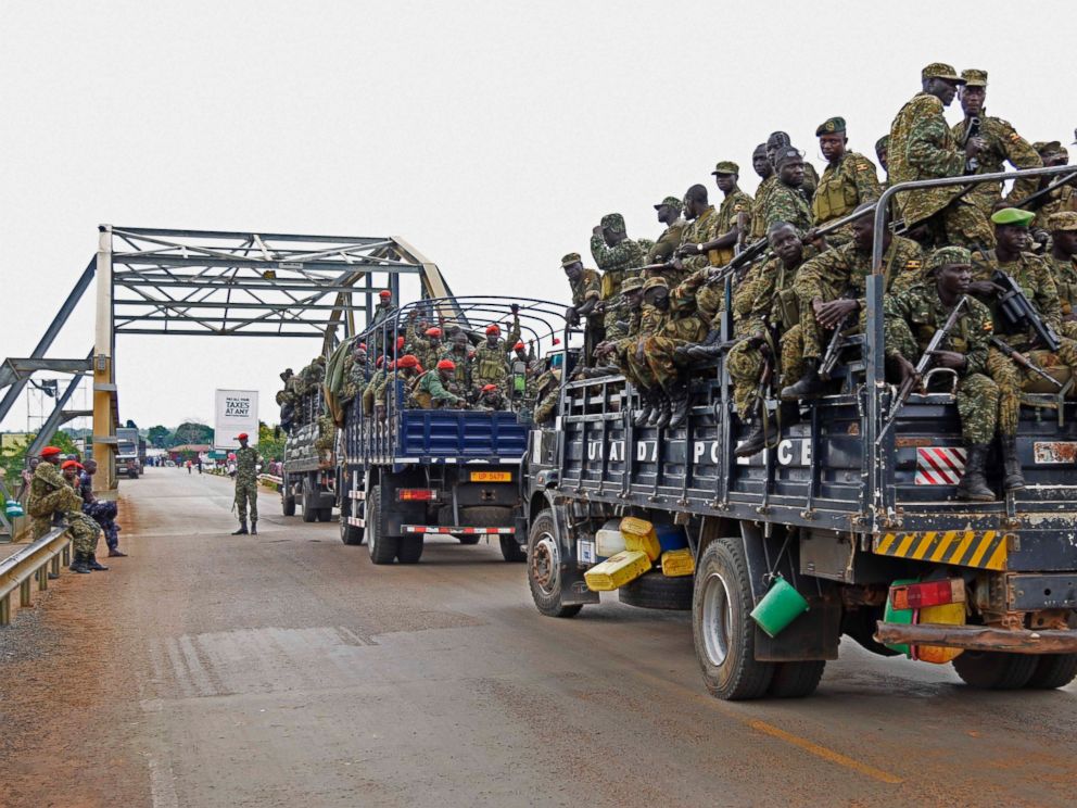 PHOTO: Uganda military personnel are seen atop military and police trucks as they drive towards Juba in South Sudan at Nimule border point, on July 14, 2016.