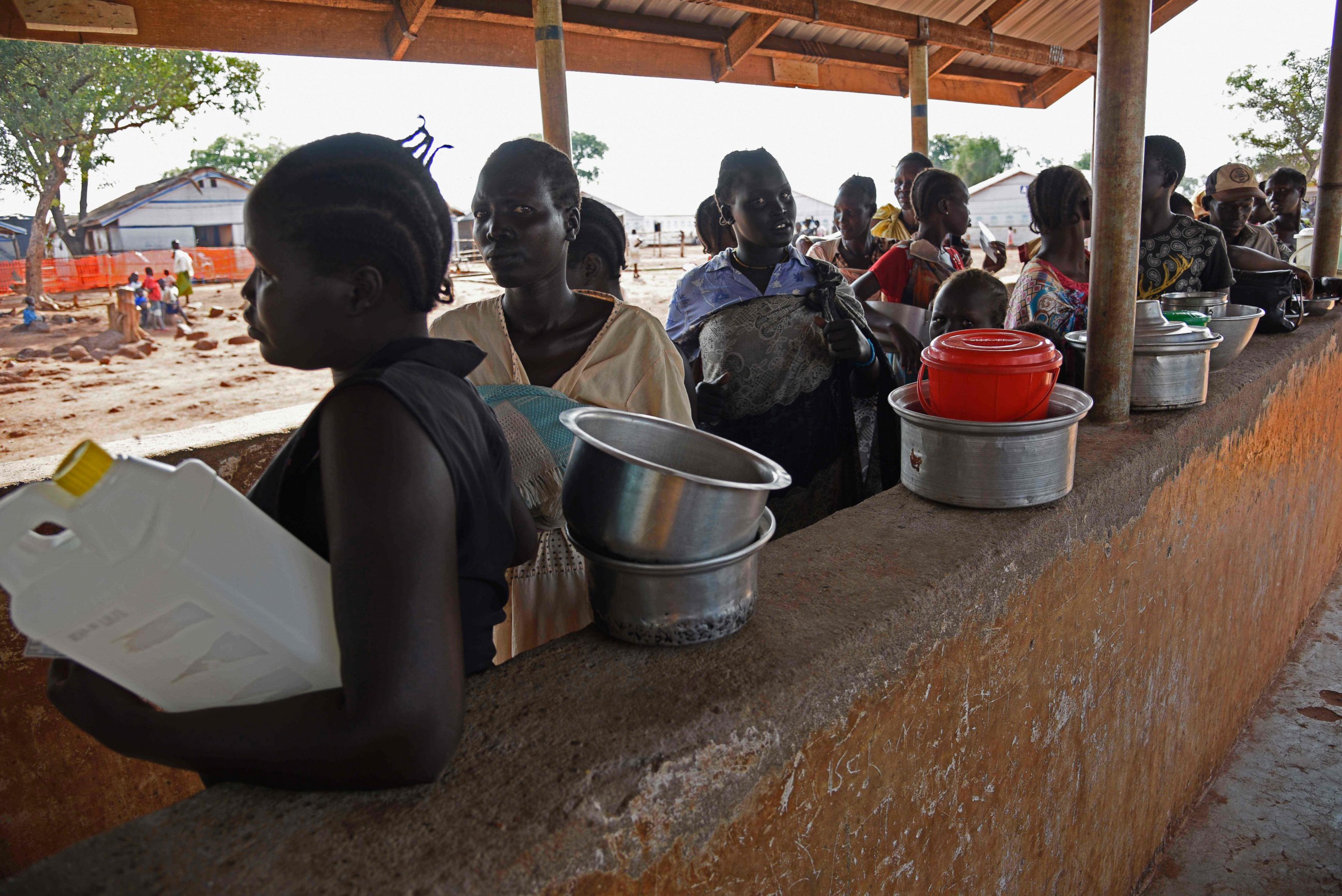 PHOTO: Newly arrived refugees from South Sudan queue to receive food at the Nyumanzi transit center in Adjumani, Uganda, on July 13, 2016.