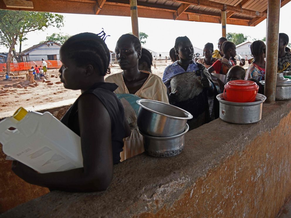 PHOTO: Newly arrived refugees from South Sudan queue to receive food at the Nyumanzi transit center in Adjumani, Uganda, on July 13, 2016.