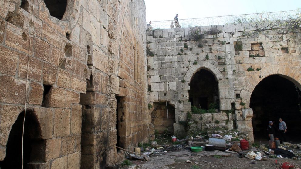 PHOTO:Syrian government forces inspect items left by rebel fighters in the famed Crusader castle, Krak de Chevaliers in the Homs region, March 21, 2014, after they recaptured the castle the previous day.