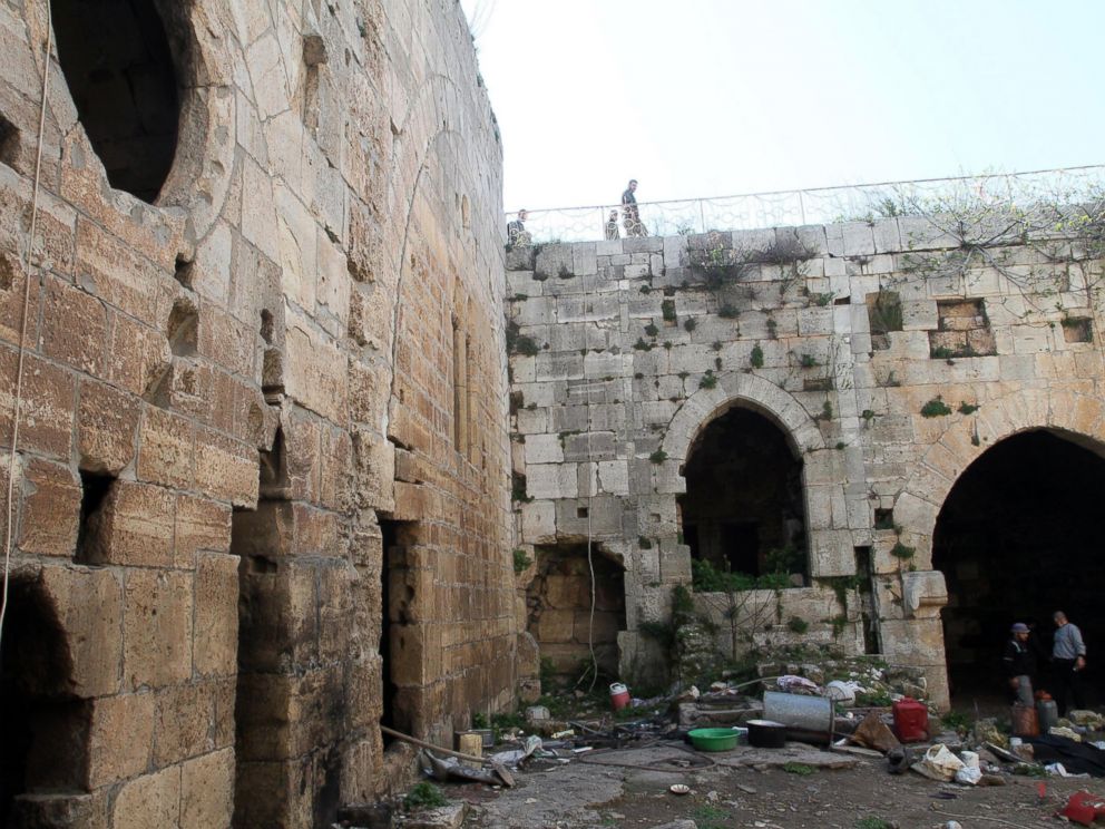 PHOTO:Syrian government forces inspect items left by rebel fighters in the famed Crusader castle, Krak de Chevaliers in the Homs region, March 21, 2014, after they recaptured the castle the previous day.