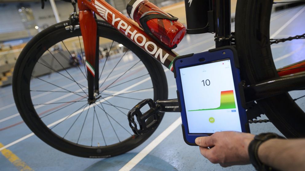 PHOTO: A staff member of the International Cycling Union (UCI) holds a tablet to scan a bicycle during a demonstration on testing for technological fraud and detecting the presence of a motor inside the frame, May 3, 2016.