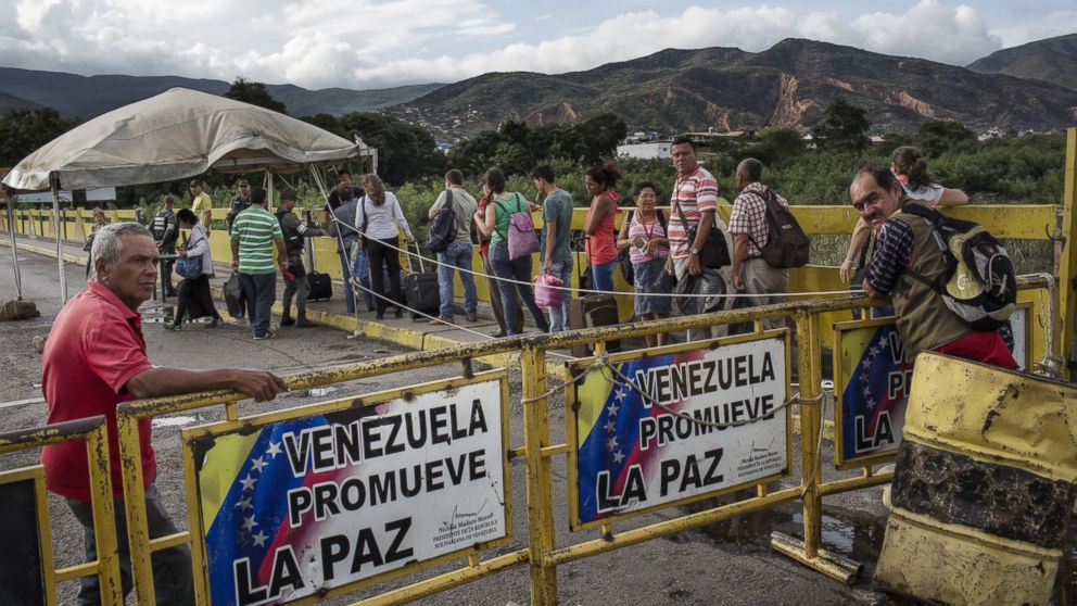 Venezuela residents cross the border bridge to return home from Colombia on July 20, 2016. When authorities temporarily opened the crossing during two weekends earlier in July, as many as 150,000 people streamed across to buy goods that are scarce in Venezuela. 