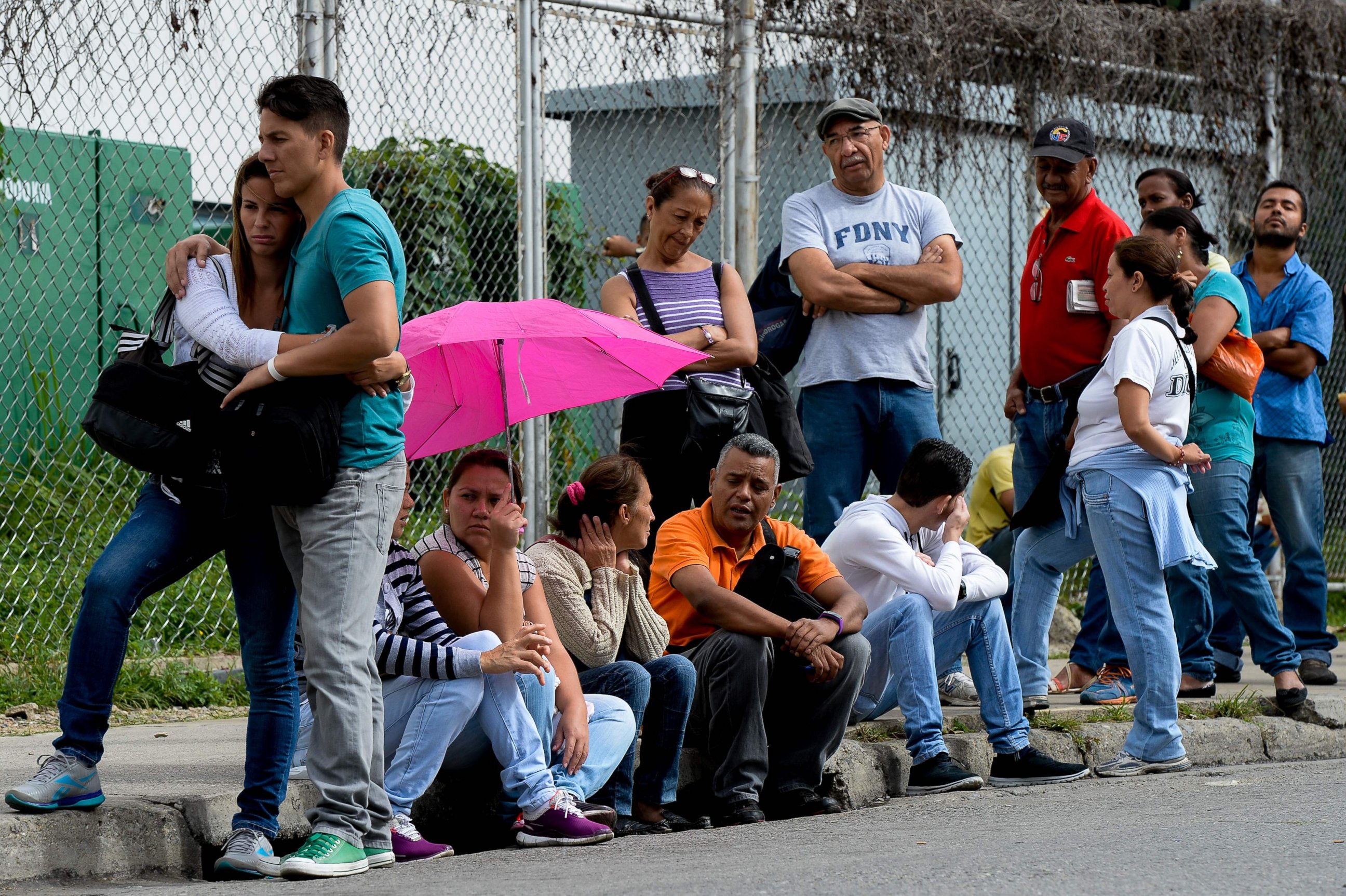 PHOTO: People queue to buy basic food and household items outside a supermarket in the Petare neighborhood, in Caracas, on June 7, 2016.  