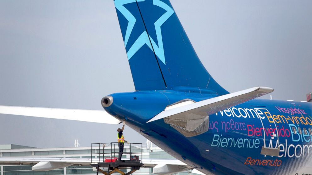 A worker inspects the rear of an Air Transat aircraft at Toronto Pearson International Airport in Toronto, July 3, 2013.