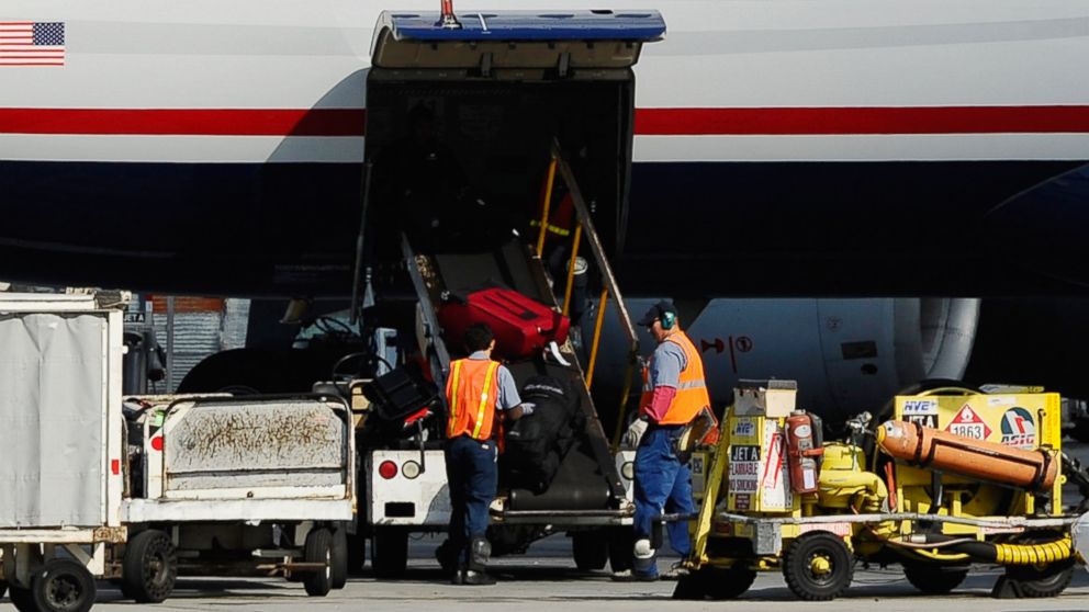 Airline workers load luggage and cargo into a US Airways passenger plane at Los Angeles International Airport on Oct. 30, 2010 in Los Angeles, Calif. 