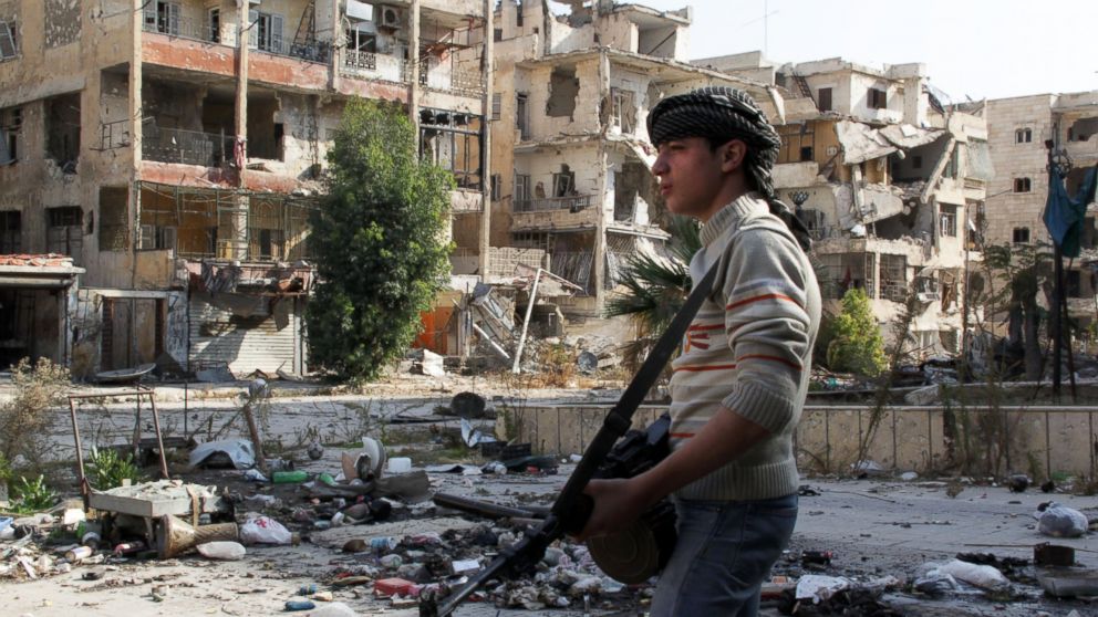 Syrian youth opposition fighter Faris, 16-years old, patrols with his weapon in the Salah al-Din neighborhood of the northern Syrian city of Aleppo, Nov. 17, 2013.