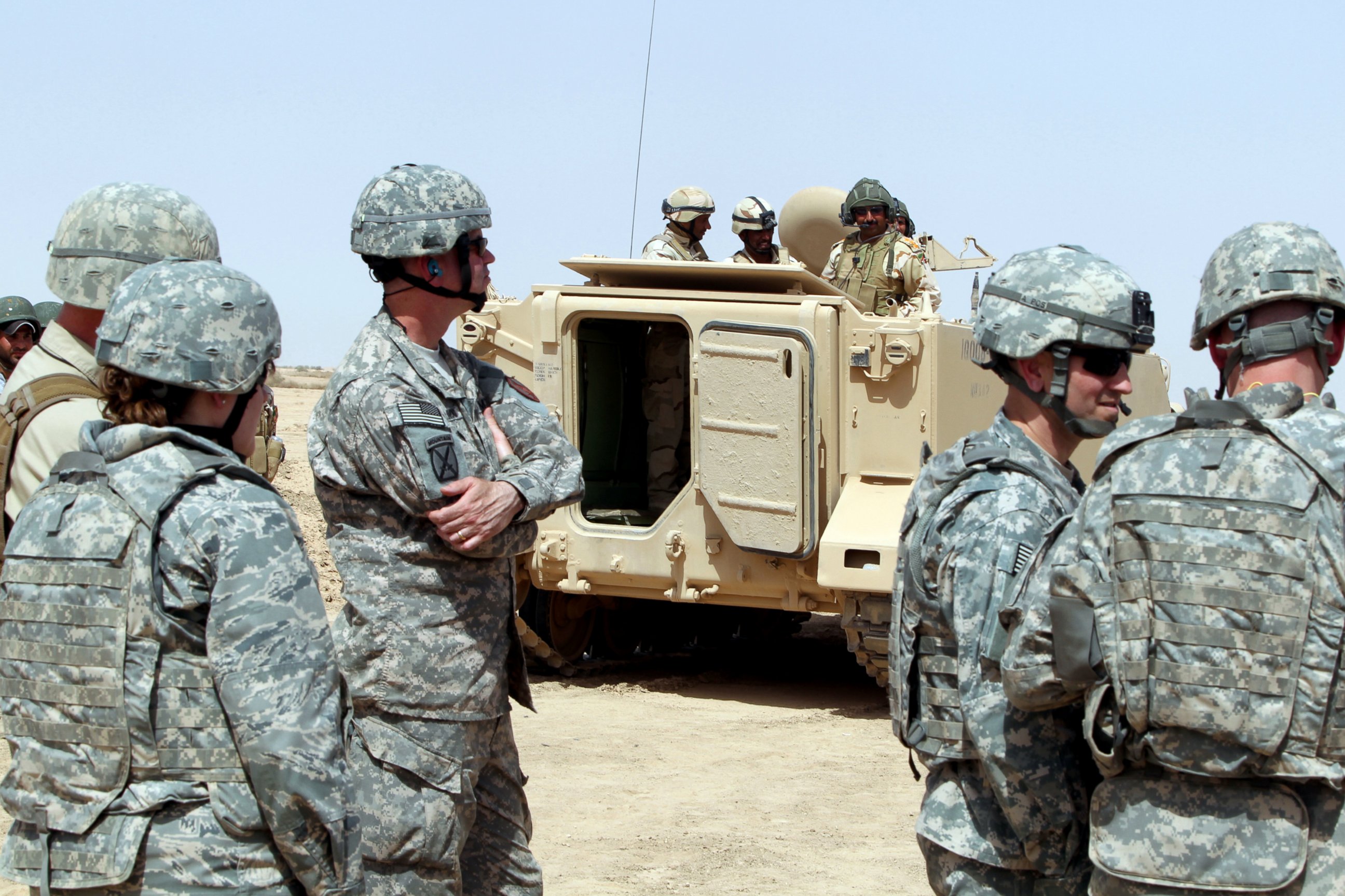 PHOTO: US military observers look on as Iraqi soldiers attend training at the Besmaya military base 