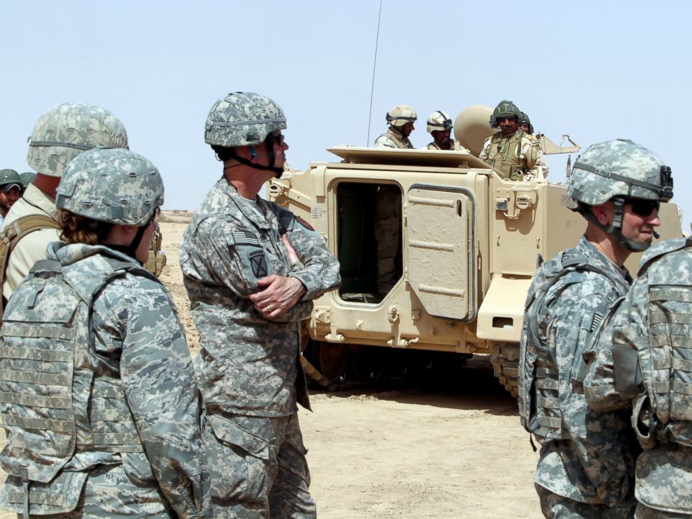 PHOTO: US military observers look on as Iraqi soldiers attend training at the Besmaya military base