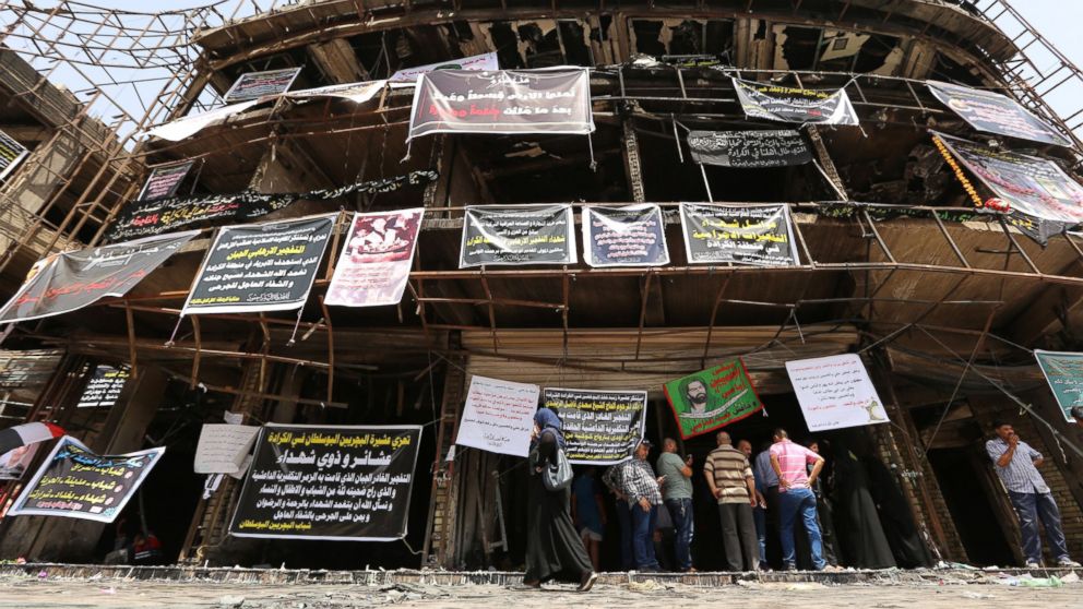 Relatives of victims gather on July 5, 2016, at the site of a suicide-bombing attack which took place two days earlier in the Karrada neighborhood of the Iraqi capital Baghdad.
