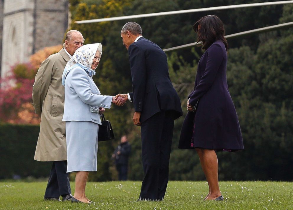 PHOTO: Former President Barack Obama and his wife former first lady Michelle Obama are greeted by Queen Elizabeth II and Prince Phillip, Duke of Edinburgh after landing by helicopter at Windsor Castle for a private lunch on April 22, 2016.