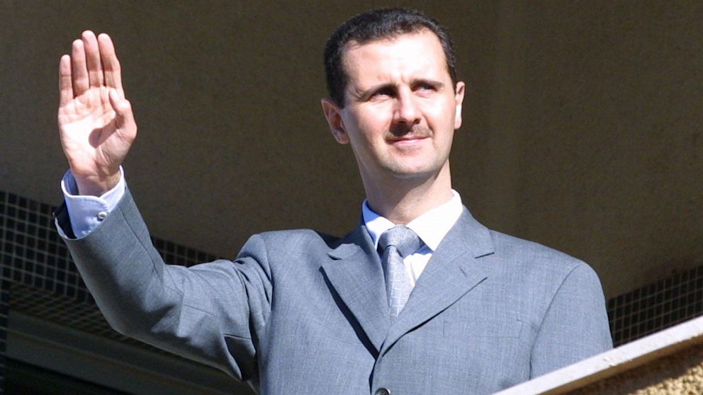 Bashar al-Assad waves from the balcony of al-Rawdha presidential palace in Damascus, March 2003, to Lebanese protesters.