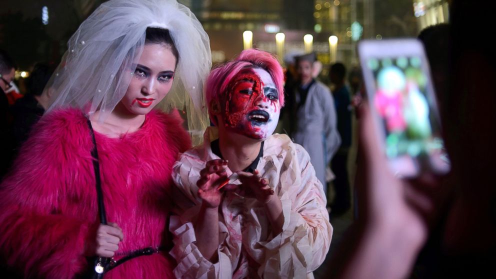 PHOTO: People in costume pose for photos as they celebrate Halloween in Beijing, Oct. 31, 2013.