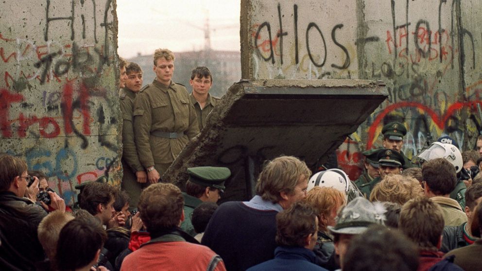 West Berliners crowd in front of the Berlin Wall, Nov. 11, 1989, as they watch East German border guards demolishing a section of the wall in order to open a new crossing point between East and West Berlin.