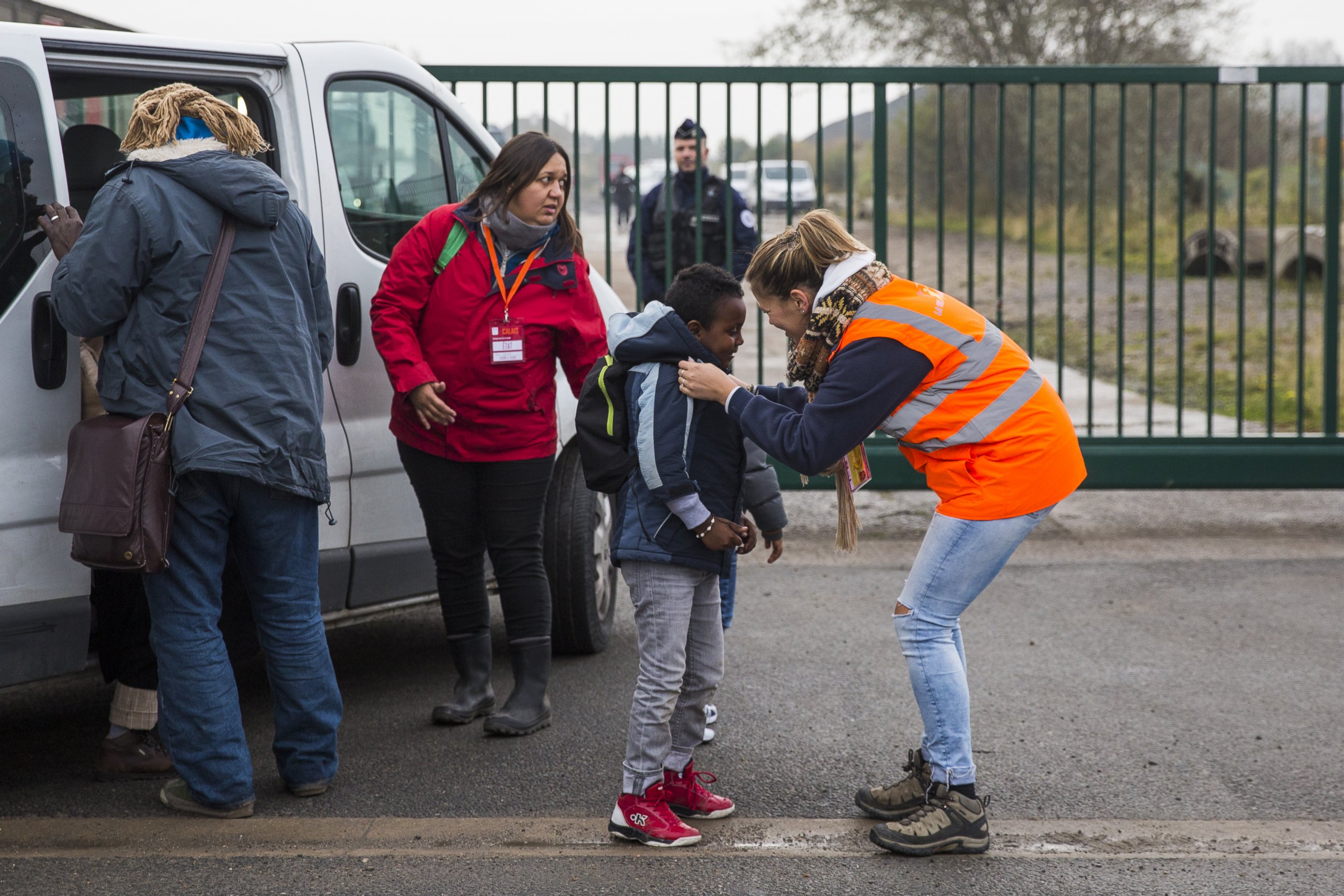 PHOTO: Care workers bring child migrants to a reception point outside the "Jungle" migrant camp before boarding buses to refugee centers around France, Oct. 24, 2016, in Calais, France.