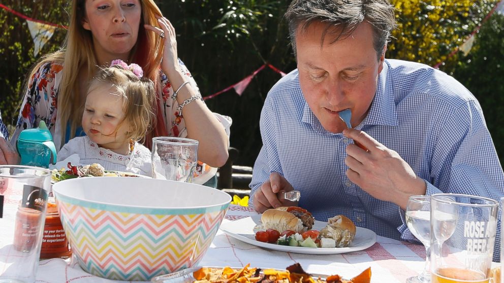 British Prime Minister David Cameron was seen eating a hot dog with a knife and fork during a campaign stop near Poole, England, April 6, 2015.
