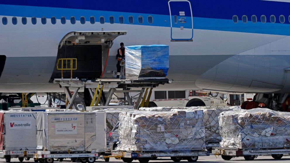 Airline workers load cargo at Los Angeles International Airport, Oct.30, 2010, one day after a plot was exposed to take down cargo planes over the United States using bombs disguised as ink cartridges.