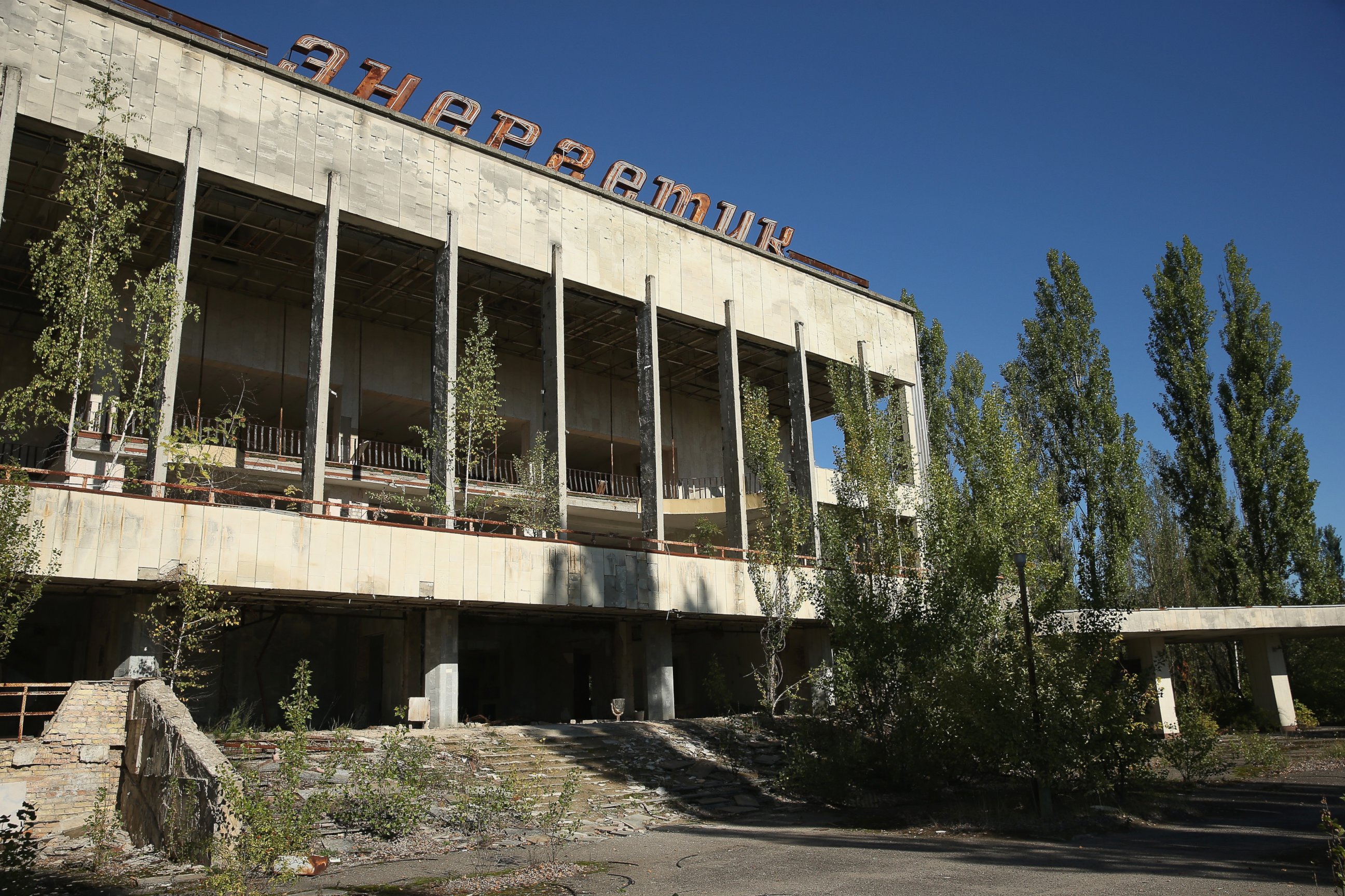 PHOTO: The abandoned "Energetik" cultural center, that once housed a library, lecture halls and sports facilities, stands on the former main square overgrown with trees, Sept. 30, 2015 in Pripyat, Ukraine.