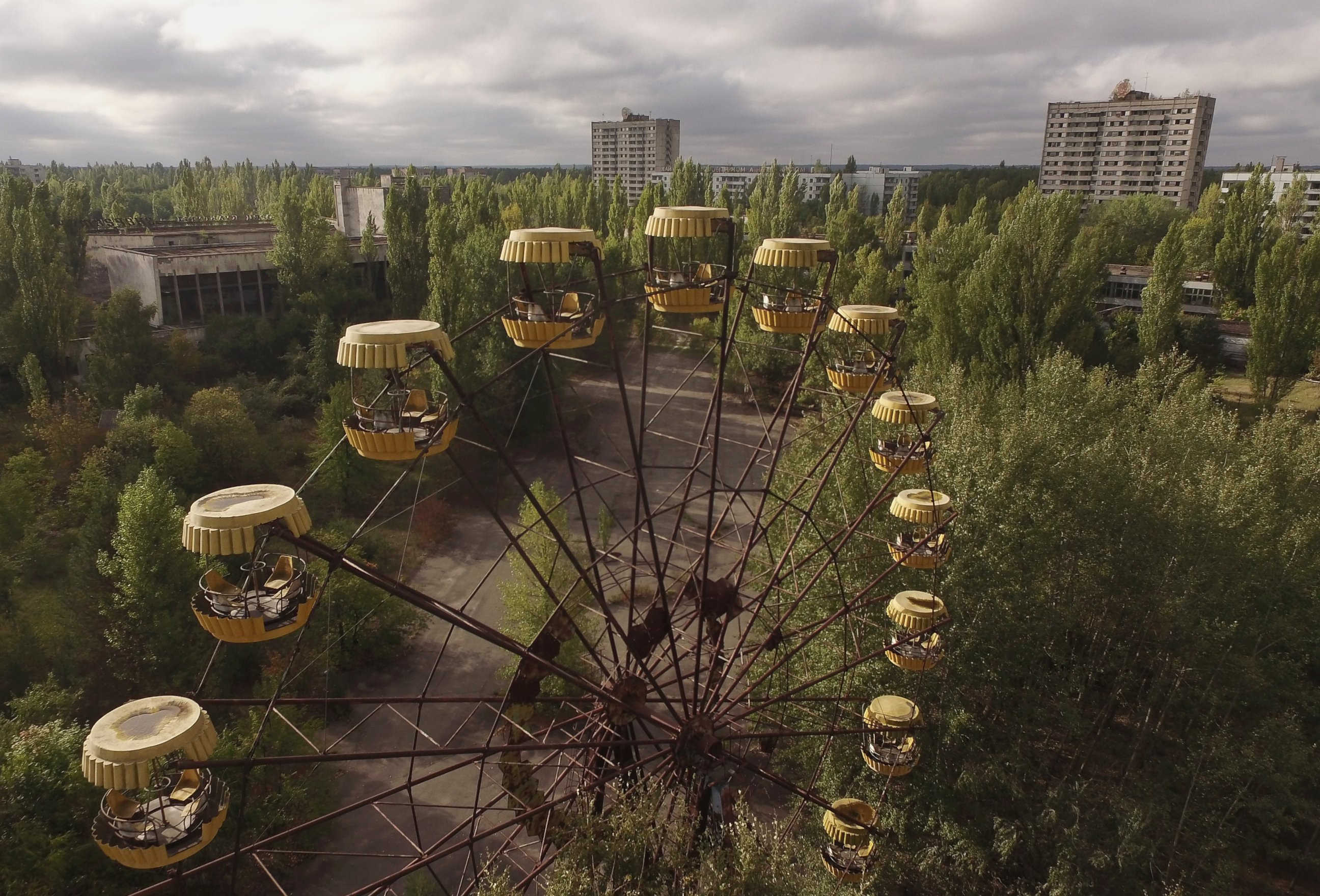 PHOTO: In this aerial view, an abandoned ferris wheel stands on a public space overgrown with trees in the former city center, Sept, 30, 2015 in Pripyat, Ukraine.