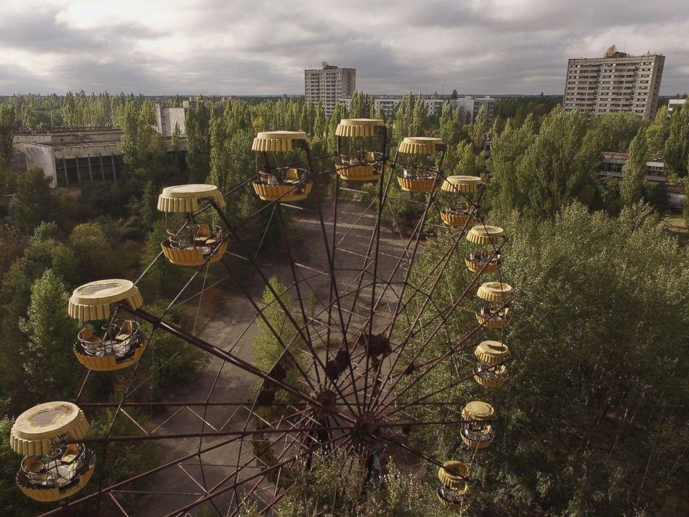 PHOTO: In this aerial view, an abandoned ferris wheel stands on a public space overgrown with trees in the former city center, Sept, 30, 2015 in Pripyat, Ukraine.