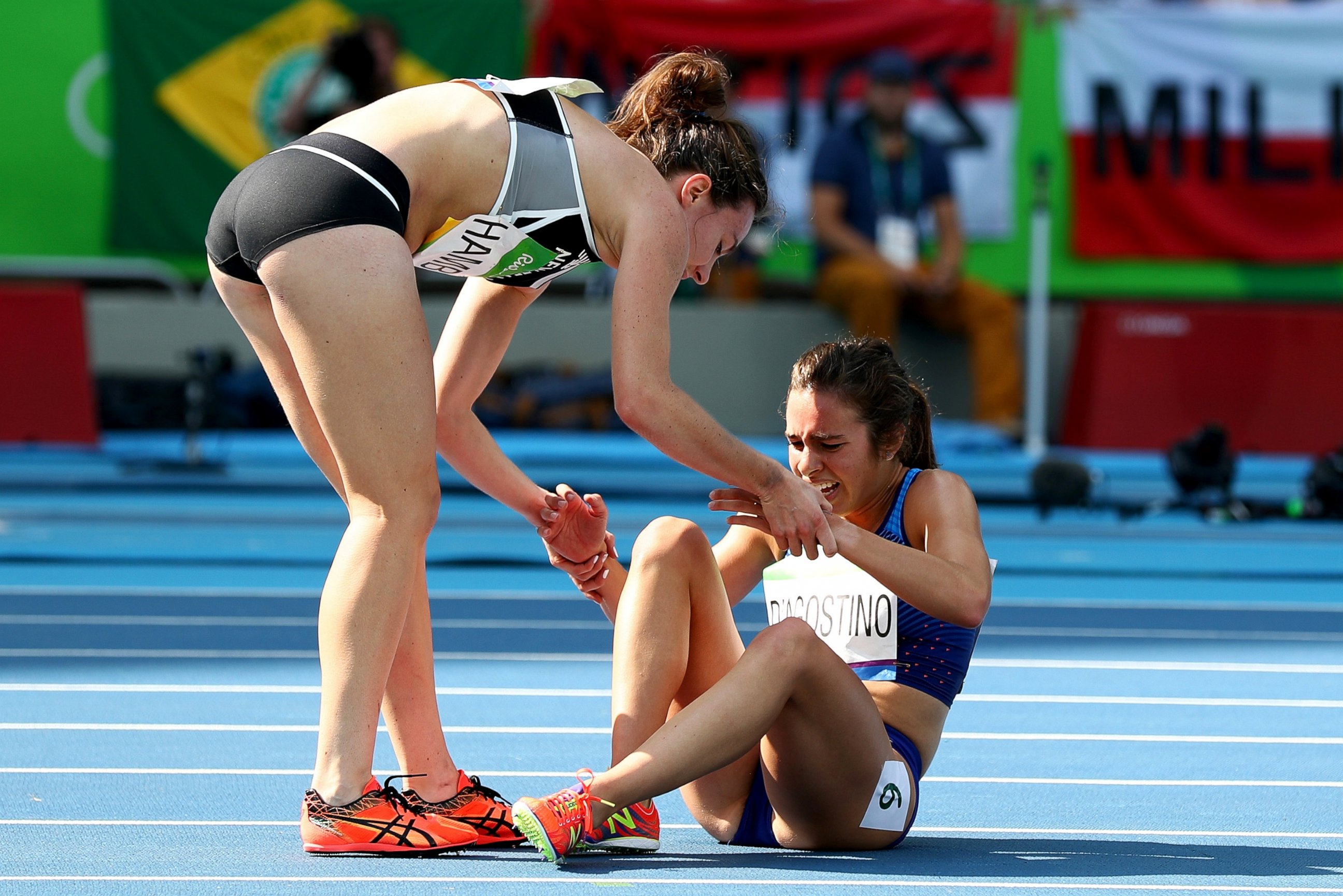PHOTO: Abbey D'Agostino of the United States (R) is assisted by Nikki Hamblin of New Zealand after a collision during the Women's 5000m Round 1 - Heat 2 on Day 11 of the Rio 2016 Olympic Games at the Olympic Stadium, Aug. 16, 2016, in Rio de Janeiro.