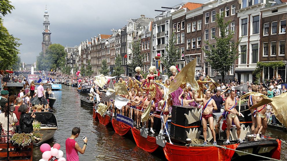 Participants of the Amsterdam Gay Pride Parade dance on boats on a canal in Amsterdam, August 4, 2012.