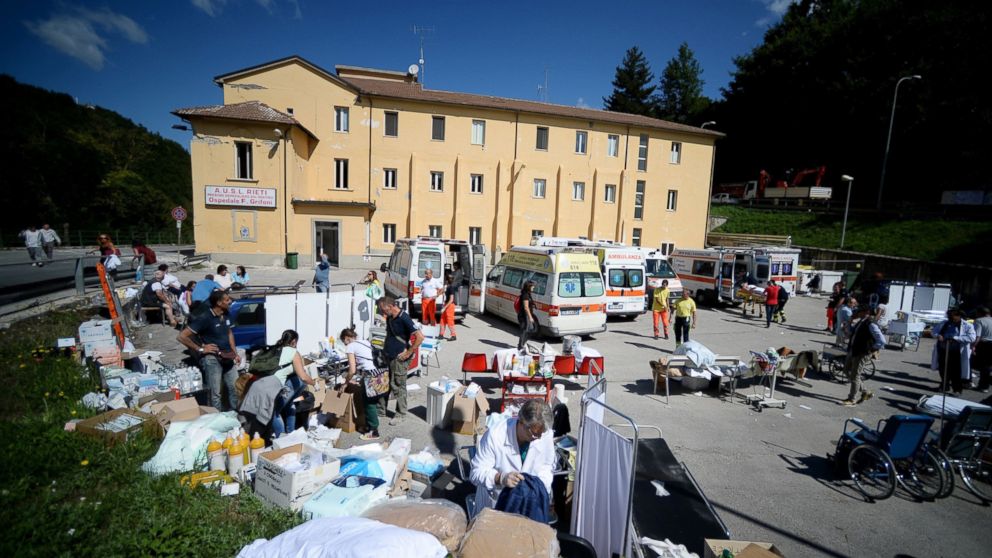 PHOTO: Rescuers set up a first aid camp in the courtyard of the hospital of Amatrice, Aug. 24, 2016, after a powerful earthquake rocked central Italy. 
