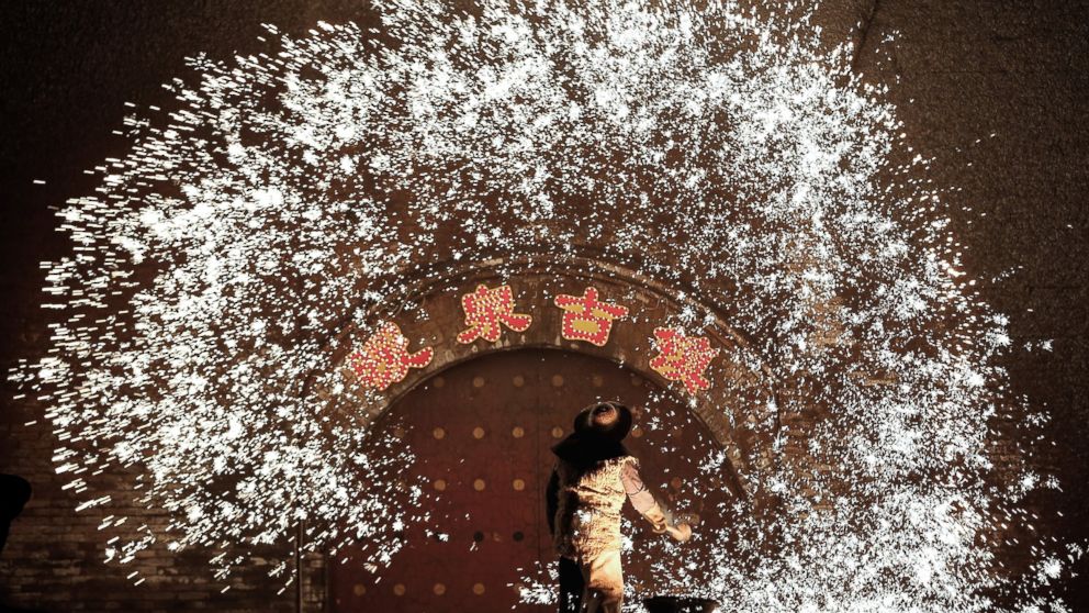 PHOTO: Throwing molten metal against a cold stone wall to create sparks has been a tradition in Nuanquan Town for over 300 years, and is believed to have come about because of the many blacksmiths of the town, Feb. 23, 2015, in Hebei Province, China. 