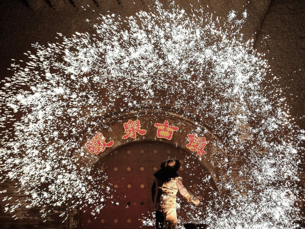 PHOTO: Throwing molten metal against a cold stone wall to create sparks has been a tradition in Nuanquan Town for over 300 years, and is believed to have come about because of the many blacksmiths of the town, Feb. 23, 2015, in Hebei Province, China.