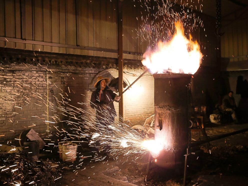 PHOTO: The throwing of ladles full of molten iron against brick walls creates a shower of sparks that looks like fireworks, Feb. 23, 2016, in Nuanquan, Hebei Province, China.