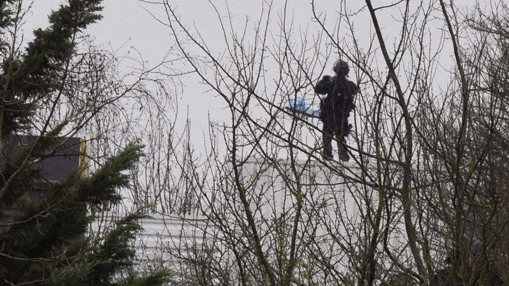 PHOTO: A French police officer stands on the roof  where two suspects in a France massacre  are believed to be holed up, Jan. 9 ,2015, in the village of Dammartin-en-Goele, Northeast of Paris.