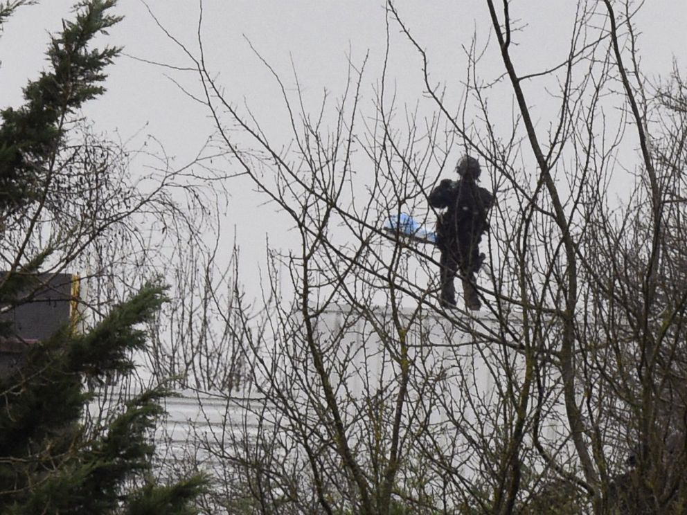 PHOTO: A French police officer stands on the roof where two suspects in a France massacre are believed to be holed up, Jan. 9 ,2015, in the village of Dammartin-en-Goele, Northeast of Paris.