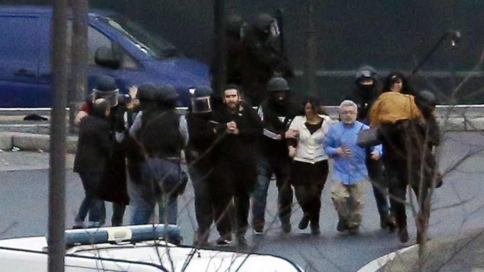 Members of the French police special forces evacuate the hostages after launching the assault at a kosher grocery store in Porte de Vincennes, Paris, Jan. 9, 2015.