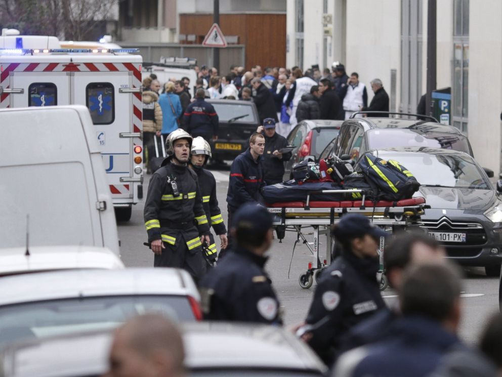 PHOTO: Firefighters push a stretcher outside the headquarters of the French satirical newspaper Charlie Hebdo in Paris on Jan. 7, 2015.