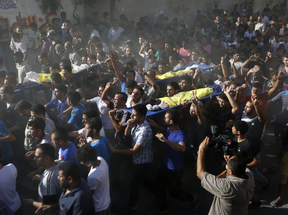 PHOTO: Palestinian mourners shout slogans during the funeral of four boys killed in an attack on a beach in Gaza City, July 16, 2014.