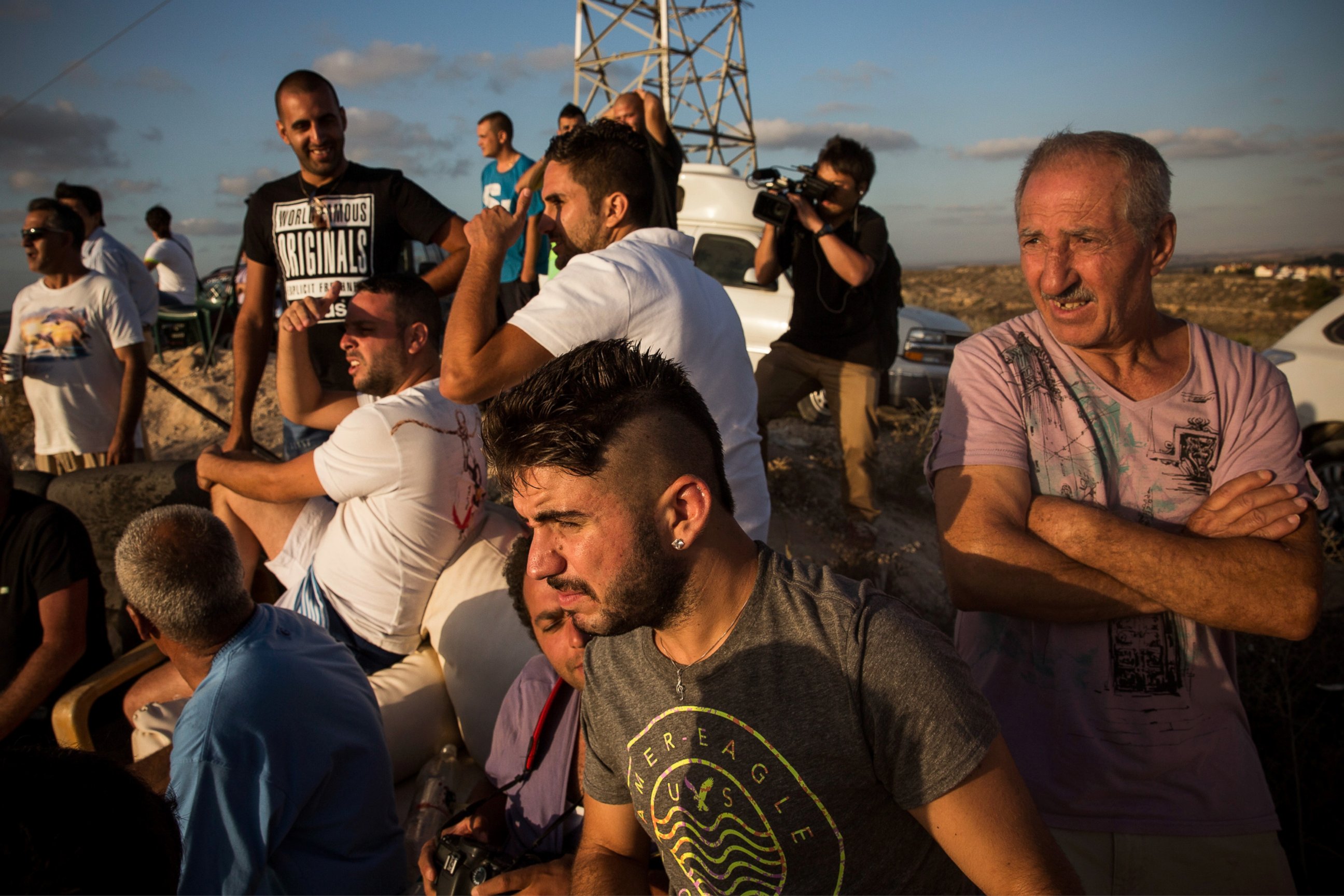 PHOTO: Civilians and members of the media wait to see Israeli attacks inside Gaza from the top of a hill on the sixth day of Israel's operation "Protective Edge" on July 13, 2014 in Sderot, Israel. 