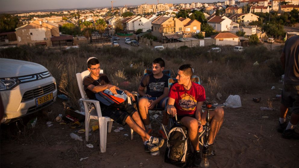 Civilians and members of the media wait to see Israeli attacks inside Gaza from the top of a hill on the sixth day of Israel's operation "Protective Edge" on July 13, 2014 in Sderot, Israel. 