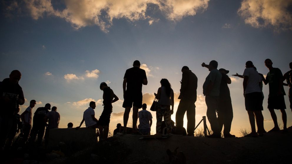 PHOTO: Civilians and members of the media wait to see Israeli attacks inside Gaza from the top of a hill on the sixth day of Israel's operation "Protective Edge" on July 13, 2014 in Sderot, Israel. 