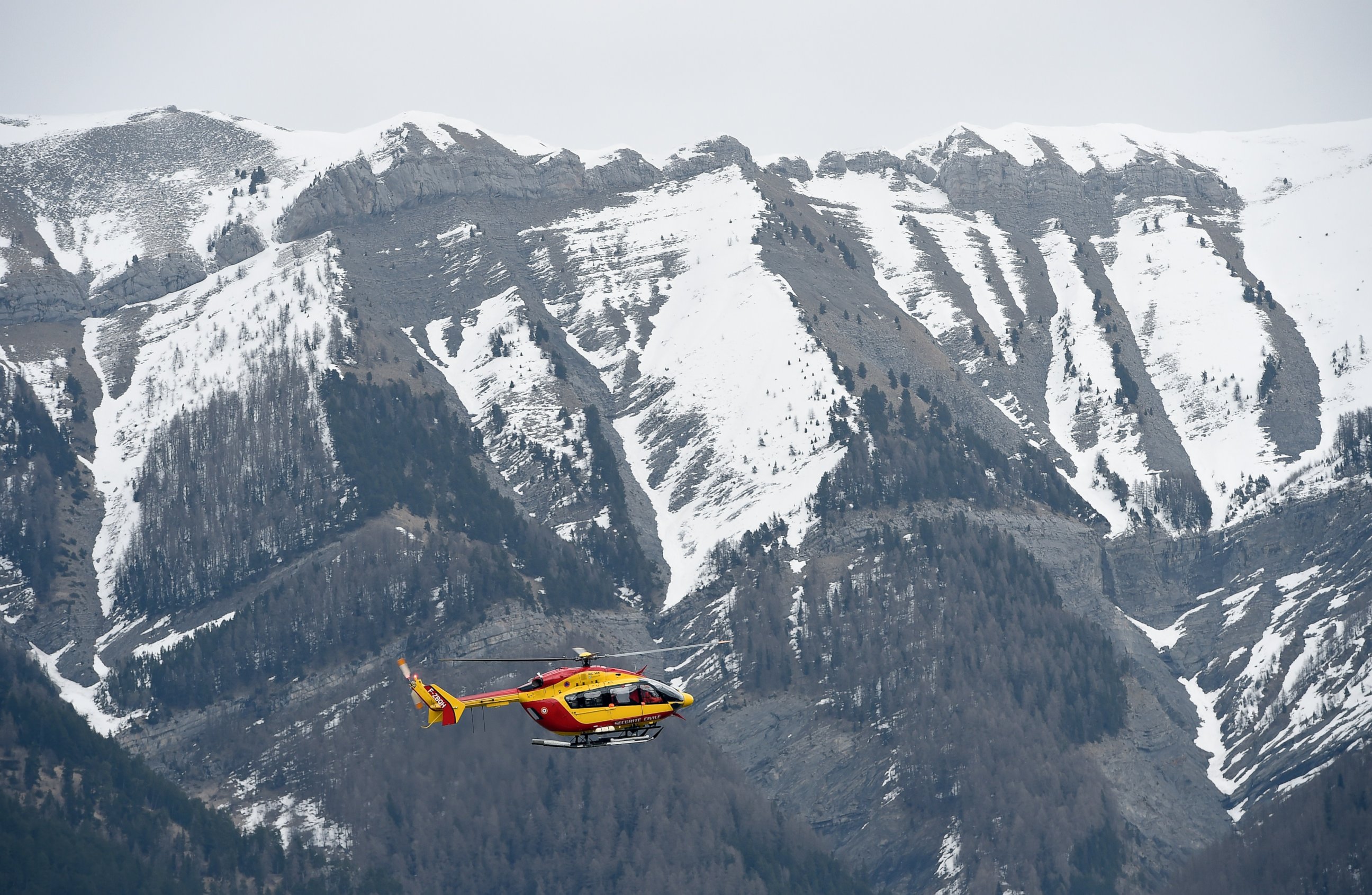 PHOTO: A helicopter of the French civil security services flies near Seyne, south-eastern France, March 24, 2015.