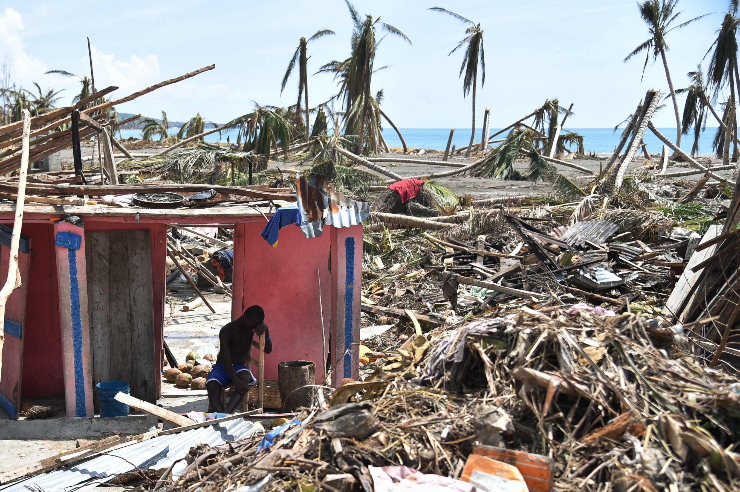 PHOTO: A man sits next to his destroyed house in Les Cayes, Haiti, Oct. 10, 2016, following the passage of Hurricane Matthew.