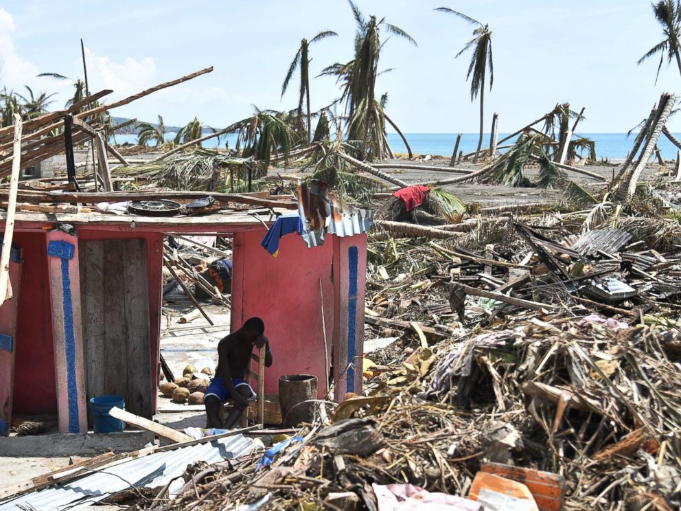 PHOTO: A man sits next to his destroyed house in Les Cayes, Haiti, Oct. 10, 2016, following the passage of Hurricane Matthew.