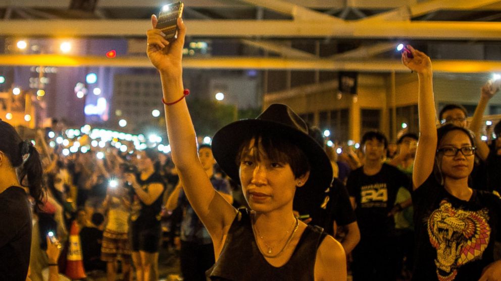 PHOTO: A protester waves her cell phone in the air outside the Hong Kong Government Complex on Oct. 1, 2014 in Hong Kong.
