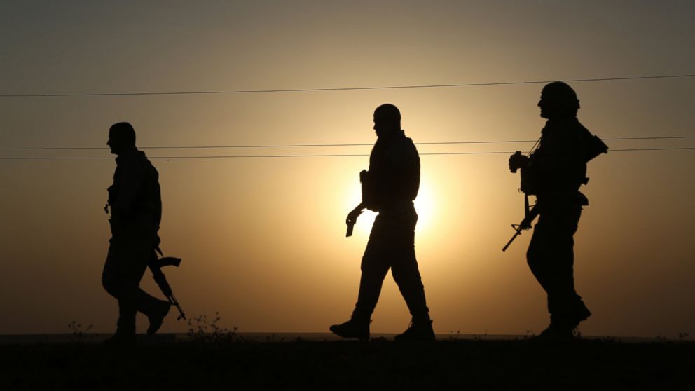 Kurdish peshmergas patrol the town of Rabia, previously seized by Islamic State of Iraq and the Levant, in Mosul, Iraq, Aug. 4,2014. 