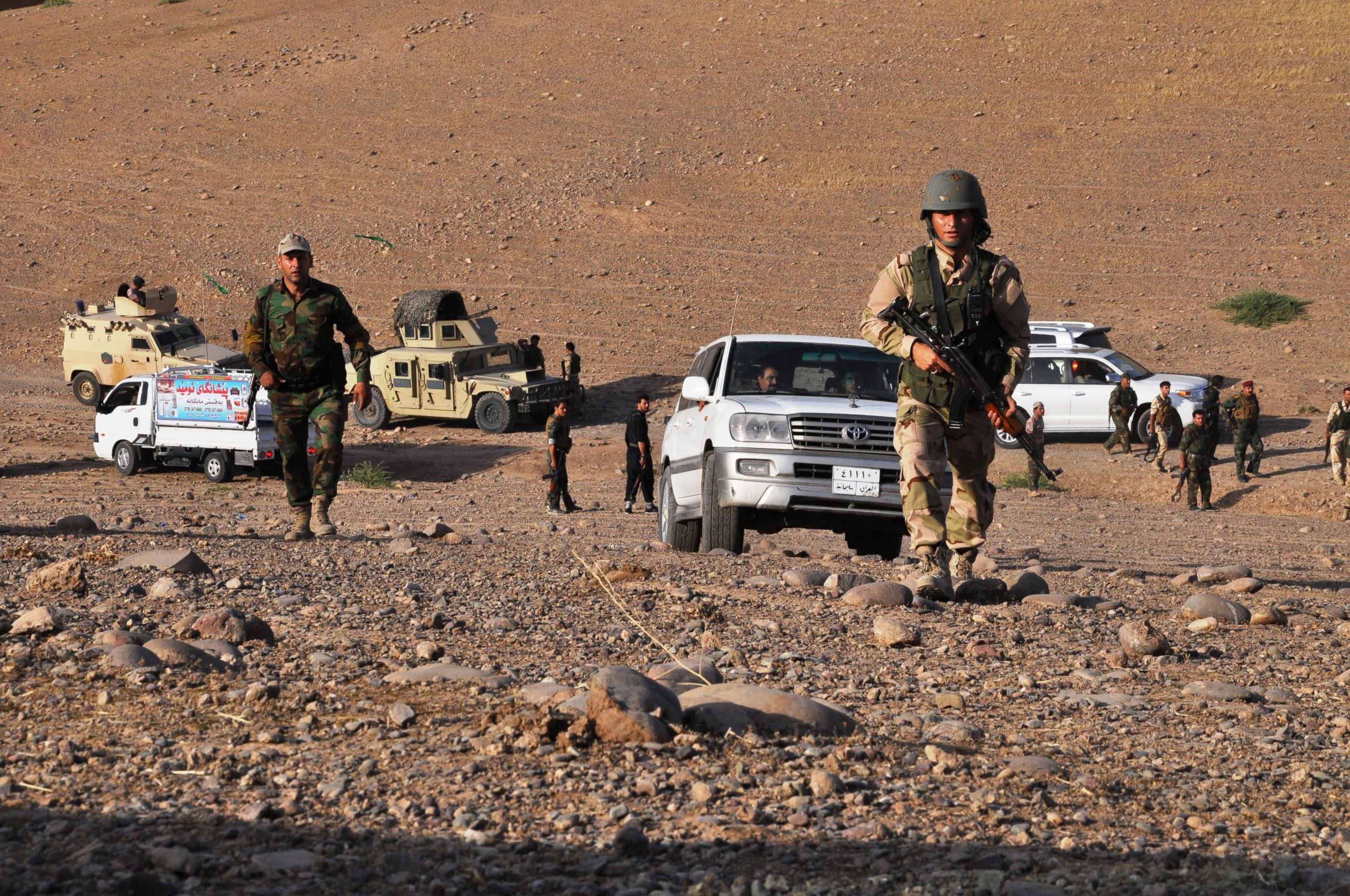 PHOTO: Members of the Kurdish Peshmerga forces take a position to fight 