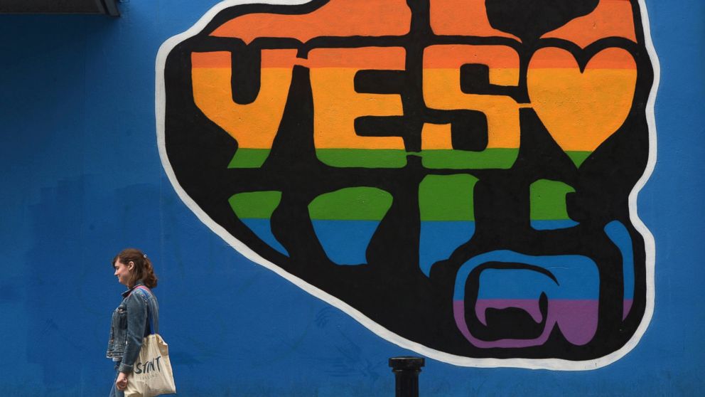 A woman walks past a mural promoting the Yes campaign in favor of same-sex marriage on May 22, 2015 in Dublin, Ireland. 