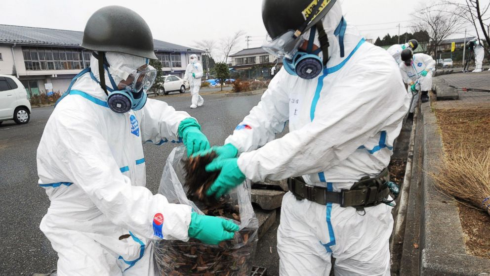 PHOTO: Japan's Self Defense Force soldiers are pictured collecting fallen leaves from a gutter as they started a decontamination mission in Namie, in Fukushima Prefecture, Japan on Dec. 8, 2011.  