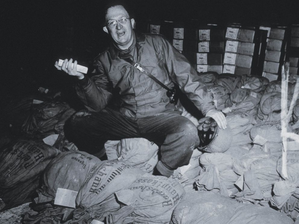 PHOTO: A U.S. soldier inspects bags of money and gold taken from Jews by the Nazis and stored in the Heilbron Salt Mines, May 3, 1945.